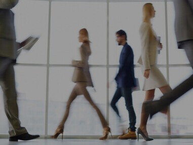 Well-dressed executives on the move, embodying the hustle of office life and career advancement