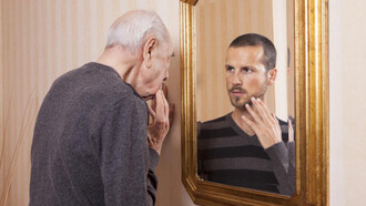 An older man looking at his younger self