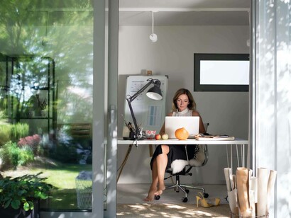 A woman working remotely with a garden view