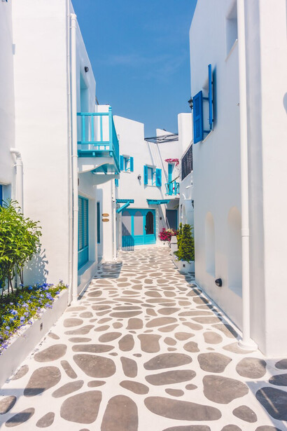 Greece's Aegean summer, featuring vibrant blue waters and quaint houses lining the coast
