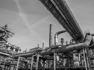 Low-angle view of a manufacturing plant against the open sky