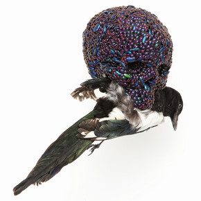 Jan Fabre, Skull with Magpie, 2001, mixture of jewel beetle wing-cases, polymers, stuffed bird, 39 x 23 x 34cm. Photo Claudio Abate, courtesy the artist and Ronchini Gallery