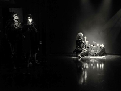 Use of symbols and imagery in the devised piece 'A Floating Caravan Under the Moon,' directed by Chiara D'Anna