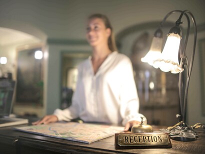 A woman working in the front desk to earn a living overseas
