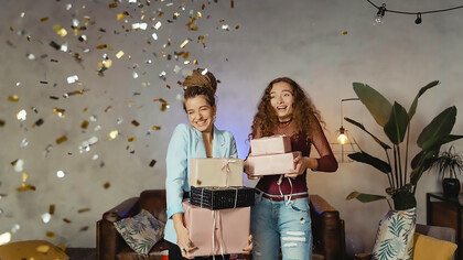 Two women joyfully exchanging thoughtful gifts, reveling in the celebration of Galentine's Day