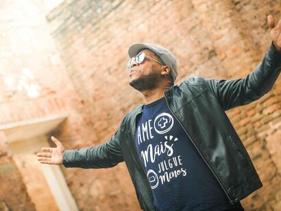 A man stretching out his arms in full gratitude for what the world has offered him up to this point