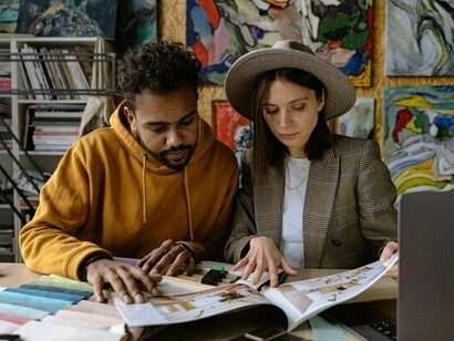 Two artists immersed in creation, representing the power of human creativity