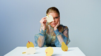 The model gazes into the lens, embodying the struggle between creativity and conformity in a rapidly changing world