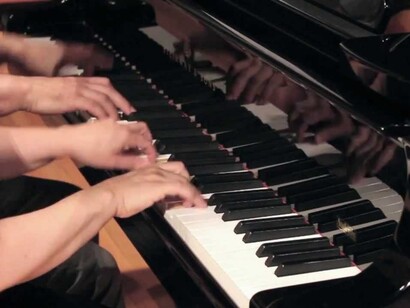 Carles and Sofia playing piano four hands