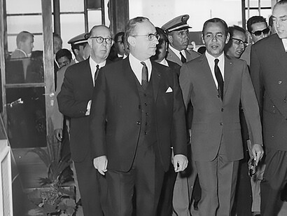 Explore a historic moment captured in a photograph featuring René Thibault, the General French Consul on the left, alongside Hassan II of Morocco at the Casablanca International Fair on 27 April 1967