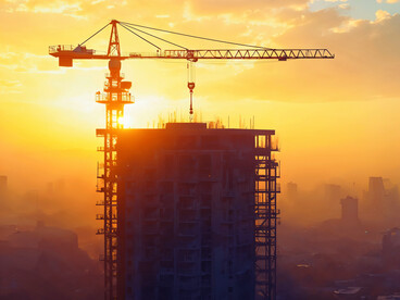 Crane extending across a construction site, reflecting the process of building in harmony with terrain conditions