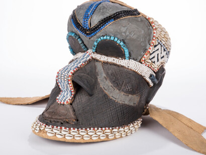 Ceremonial Mask, Bakuba (Kuba) Zaire, Democratic Republic of Congo, wood and burlap with cowrie shells and beads. John L. Warfield Center for African & African American Studies.