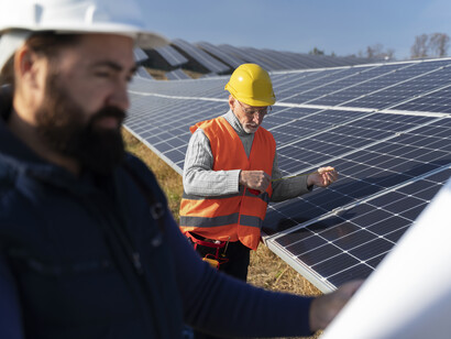 Technicians setting up solar panels 