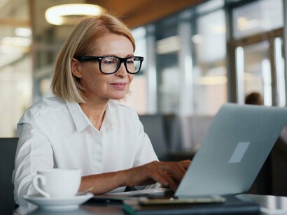 A business professional working attentively on a laptop, symbolizing employee awareness as a key defense against cyber threats