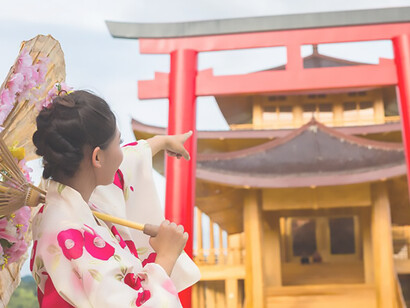 Stunning image of an Asian woman adorned in a Japanese kimono, standing gracefully in front of a Torii gate at the entrance of Tatsuta Shrine, Japan, capturing the essence of traditional Japanese culture and spirituality