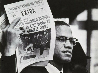 Malcolm X holding up Black Muslim Newspaper, Harlem, New York, Gordon Parks, 1963