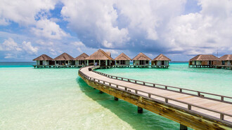Stunning overwater bungalows perched above the crystal-clear waters of the Maldives