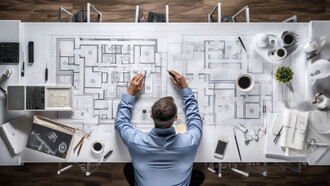 Architect meticulously crafting a blueprint at his office desk, exemplifying precision and dedication in architectural design