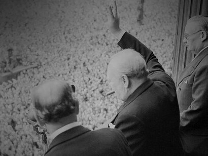 Winston Churchill giving the "V" sign on Victory Day to a huge crowd in 1945 in England 