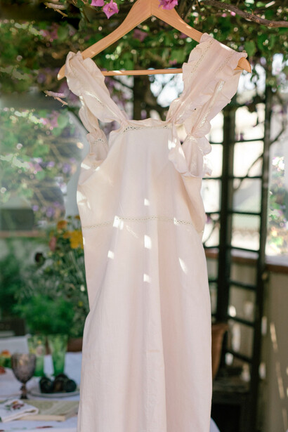White dress hanging in the gazebo garden
