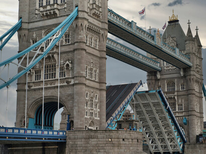 Tower Bridge in London, United Kingdom, standing majestically beneath a dramatic cloudy sky