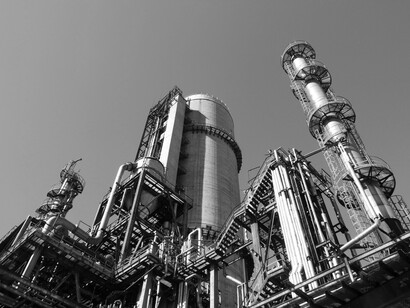 Low-angle shot of a manufacturing plant framed by the sky