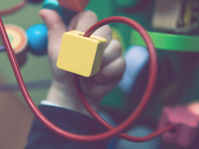 A young boy immerses himself in a world of joy and imagination, exploring the wonders of play with his cherished toys