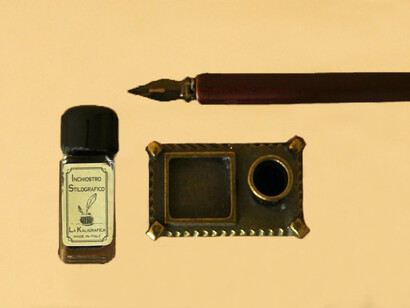 On the table,a pen, an ink bottle arranged