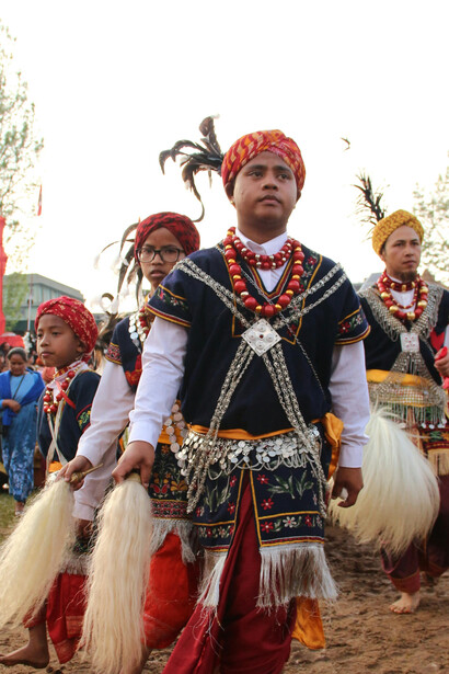 A traditional Khasi cultural parade in Meghalaya, India, featuring performers dressed in colourful indigenous attire and ceremonial clothing