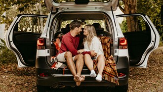 A couple in the trunk of the car are dismissing the talk of marriage and kids on a date