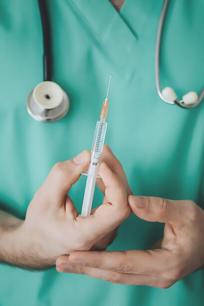 Captured in a poignant moment, a doctor's hand carefully grips a vial of essential vaccine, highlighting the pivotal role of medical experts in delivering vital healthcare solutions