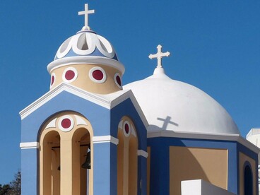 An orthodox church in Fira, Santorini, Greece, symbolising the cultural legacy preserved through both religion and language