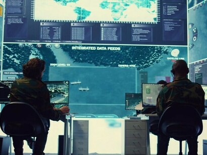 Military crew working in a high-tech control room, monitoring multiple screens in a cyber security and reconnaissance operations center