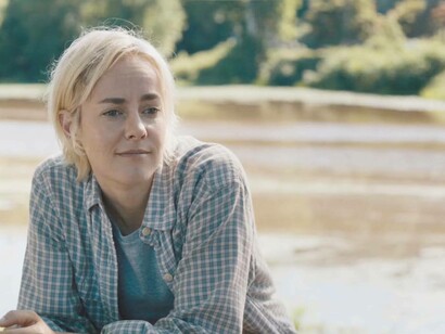 Jena Malone looking on sarcastically in this scene from Adopting Audrey (2022) which was released in August