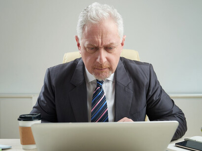 Senior businessman in the workplace, baby boomers at work, and maintaining work-life balance