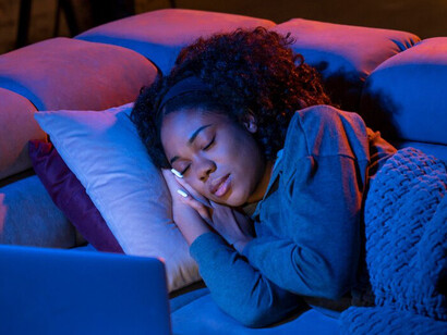 Streaming services are experimenting with interactive content, and this woman is fully immersed in an engaging, choose-your-own-adventure show, reflecting the future of how we engage with entertainment