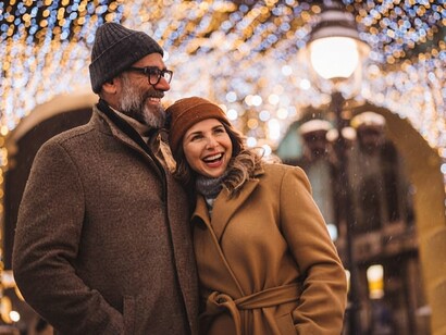 A mature couple having fun while strolling through the city on a winter day