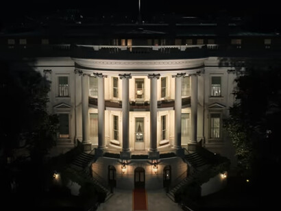 A dimly lit White House with a glowing red carpet leading to its entrance serves as a symbol of power in The Residence, where staff and secrets collide in a high-stakes whodunit