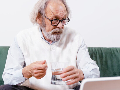 A senior takes his daily probiotic supplement, supporting digestive balance and overall immune health