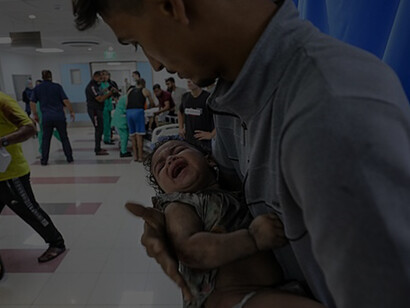 Medics transport an injured Palestinian child into Al-Shifa hospital in Gaza City following an Israeli airstrike on October 11, 2023