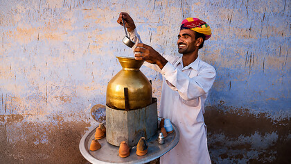 Street vendor preparing and serving masala chai in Jaipur, India