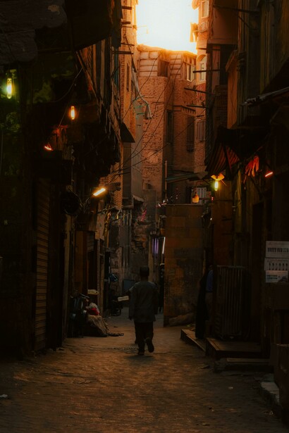 Narrow streets of old Cairo at dusk, bathed in warm, nostalgic light, Egypt