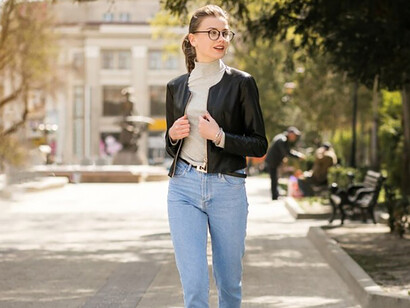A happy woman walking outdoors during the daytime