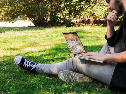 A recent college graduate sits at a laptop, navigating job portals with a mix of anxiety and confusion about the future