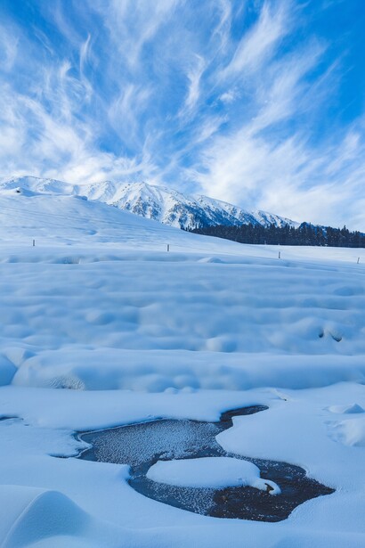 A snowy mountain on a clear day. Climate change is a problem closely connected to social justice