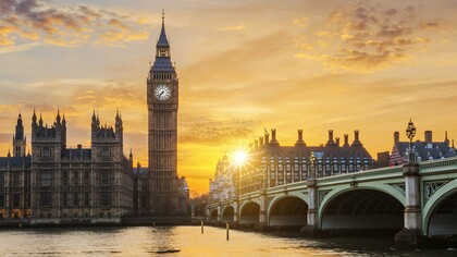 A golden sunset casting long shadows over Westminster and the Thames, representing the fading glow of Britain’s former global authority