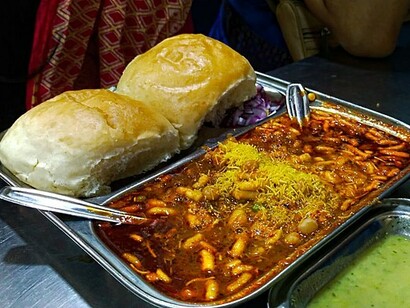 A typical marathi dish called missal pav. It has a soft bread which is known as pav and misal is a spicy curry made up of moth beans often served in India 