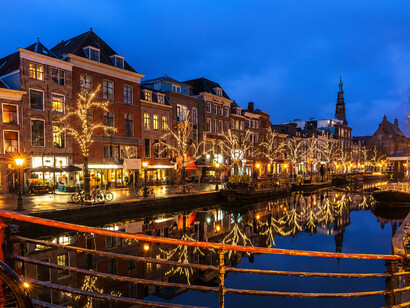 Festive Christmas lights illuminate the historic canals of Leiden, Netherlands