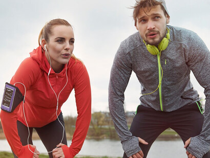 A happy couple running outdoors, enjoying a long-distance workout together