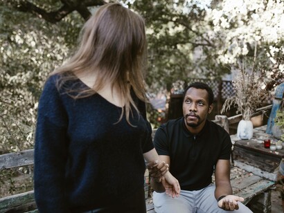 A man trying to explain to his partner that his cheating will never happen again